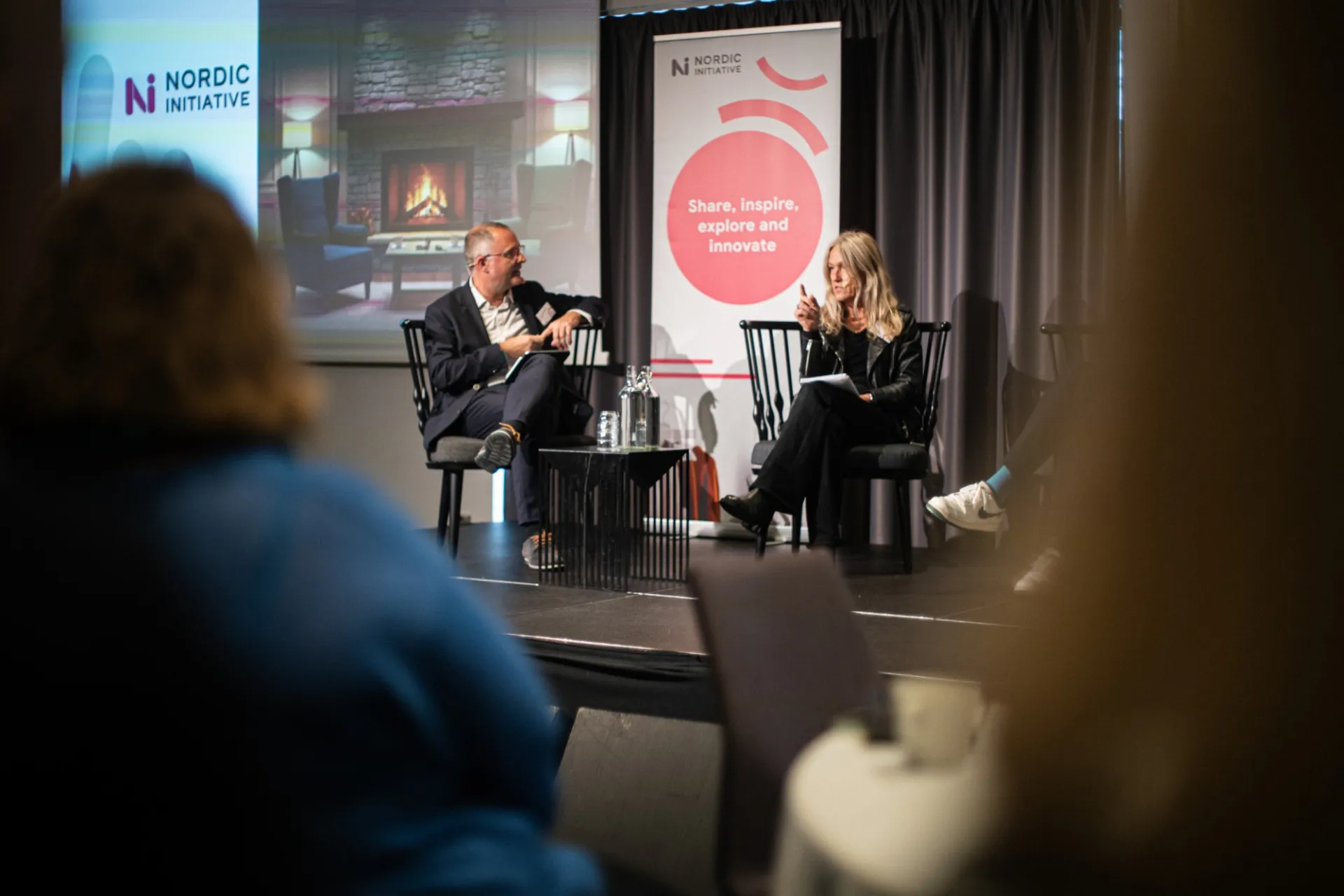 Birgitta Söderlund-Rietz moderating a fireside chat on stage at a Nordic Initiative gathering